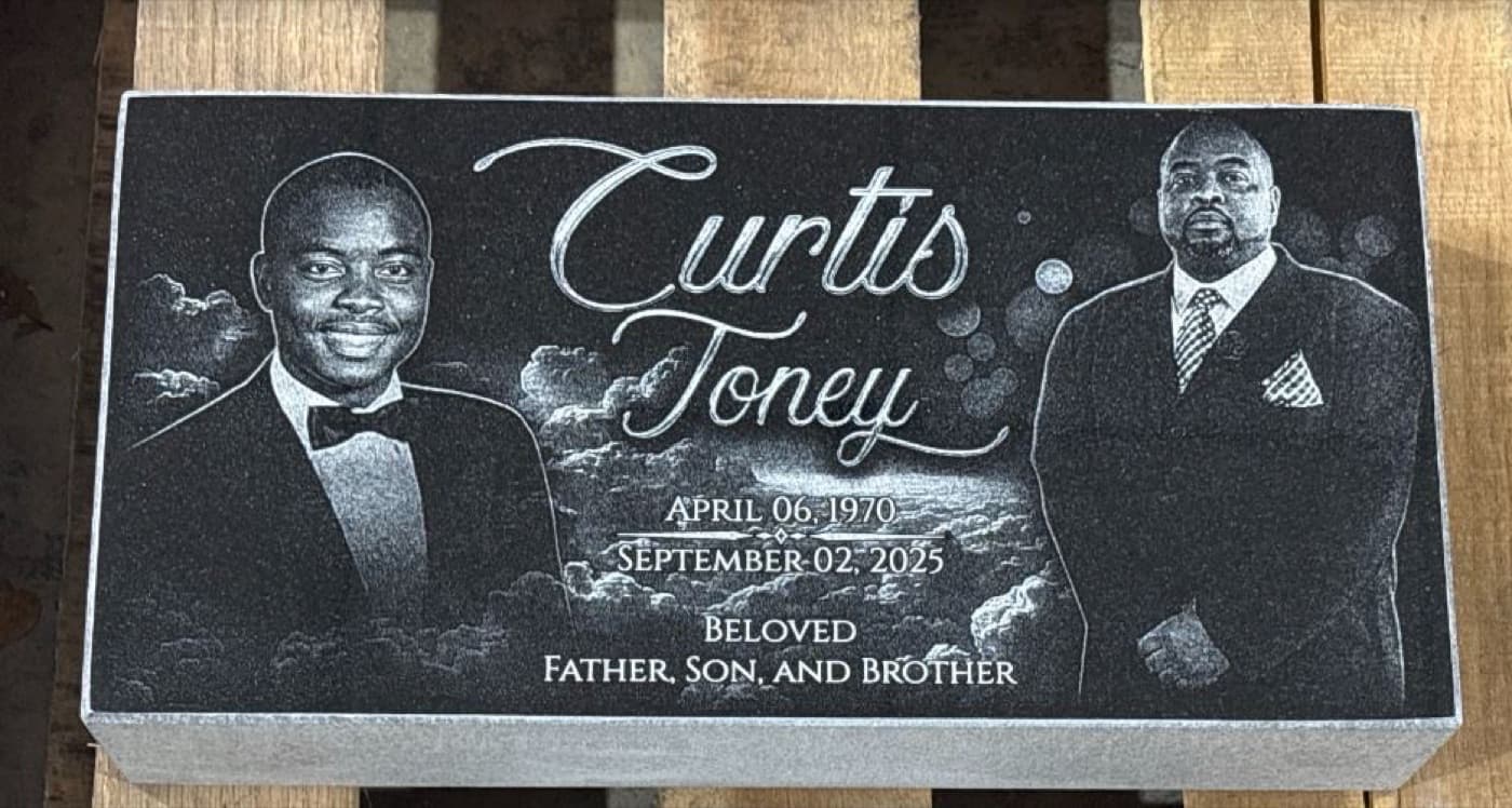 Flat bevel-style marker for Curtis Toney — side-by-side dual portrait with 'Beloved Father, Son, and Brother' inscription on black granite