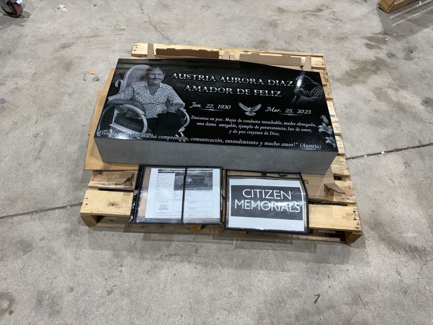 Flat marker for Austria Aurora Diaz Amador de Feliz — seated portrait, dove motif, and Spanish-language epitaph engraved on polished black granite