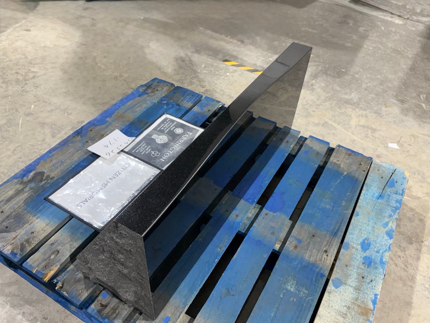 Polished black granite slant headstone blank — showing the classic steep-angled profile and base dimensions before engraving