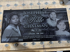 Memorial plaque with black and white photos of a woman and two children, text, and a quote.
